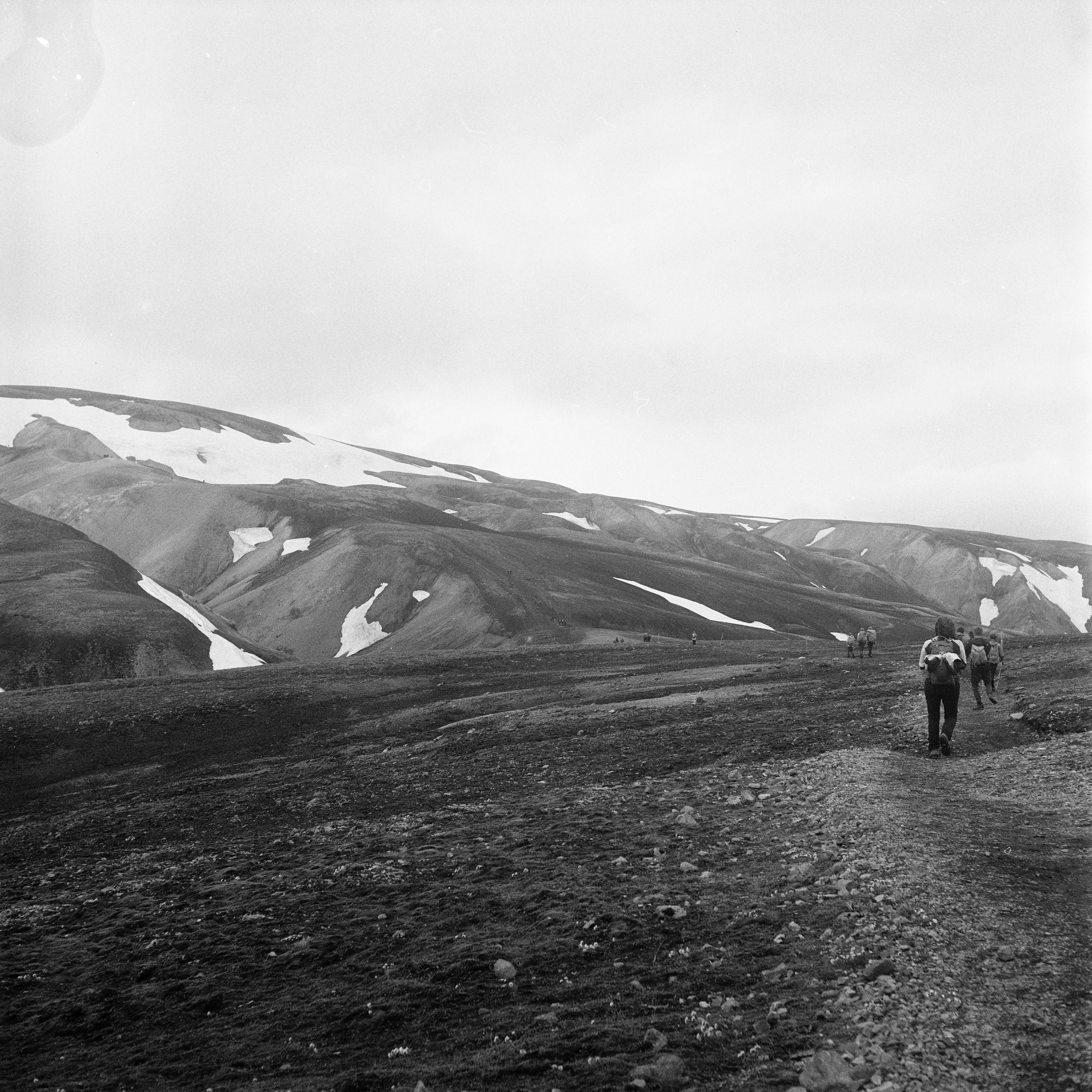 People hiking on sand