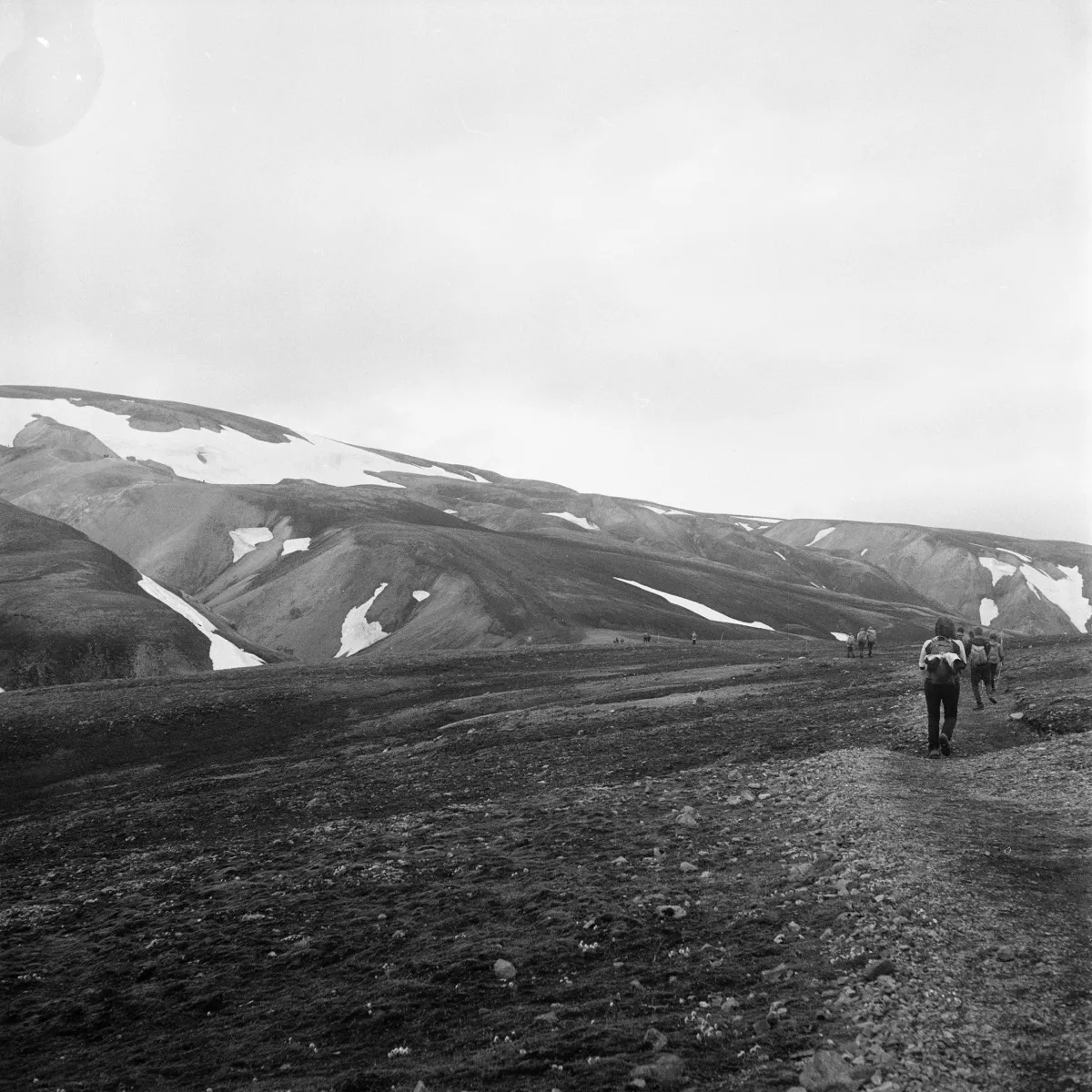 People hiking on sand